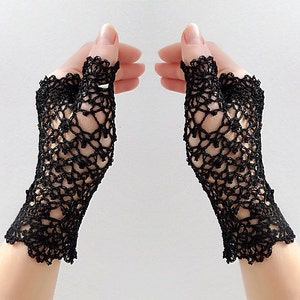 May include: A pair of black fingerless lace gloves with a delicate crochet pattern.