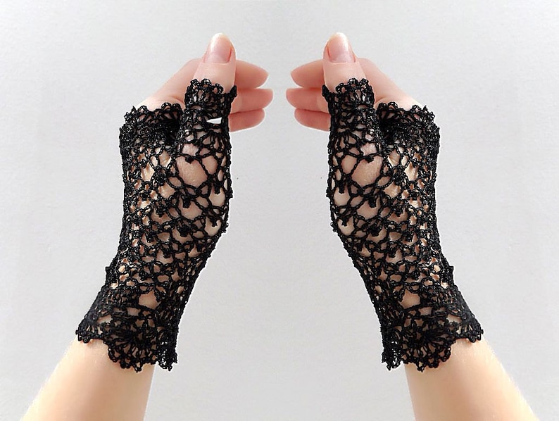 May include: A pair of black fingerless lace gloves with a delicate crochet pattern.