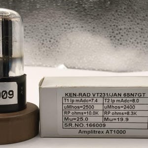Könnte beinhalten: Eine klare Glas-Vakuumröhre mit schwarzen Innenkomponenten und einem schwarzen Sockel mit der Aufschrift 166009, neben einer rechteckigen Schachtel. Das Etikett lautet KEN-RAD VT231/JAN 6SN7GT, T1 Ip mAdc=7.4, T2 Ip mAdc=8.0, uMhos=2500, uMhos=2400, RP ohms=10.0K, RP ohms=8.3K, Mu=25.0, Mu=19.9, SR.NO.166009, Amplitrex AT1000.