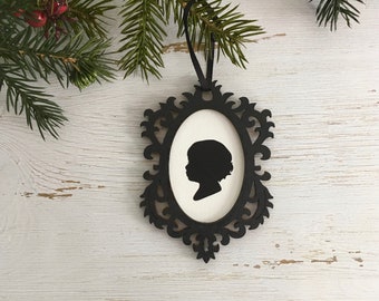 Custom silhouette in a black laser cut frame with a wooden white center