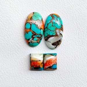 May include: Four polished turquoise and orange gemstone cabochons. Two are oval-shaped, and two are rectangular. The stones have a matrix of brown and gold veins. The background is white.