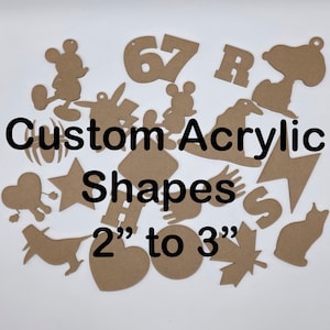 May include: A collection of custom acrylic shapes in various designs, including Mickey Mouse, Snoopy, and a cat. The shapes range from 2 to 3 inches in size and are made of a light brown material. The text "Custom Acrylic Shapes" is displayed.