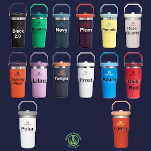 May include: A collection of Stanley tumblers in various colors, including black, green, navy, plum, yellow, and pink. Each tumbler has a handle and a lid. The text on the tumblers includes color names and the Stanley logo.