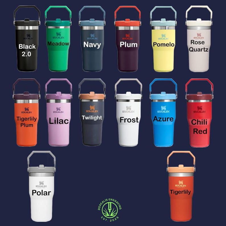 May include: A collection of Stanley tumblers in various colors, including black, green, navy, plum, yellow, and pink. Each tumbler has a handle and a lid. The text on the tumblers includes color names and the Stanley logo.