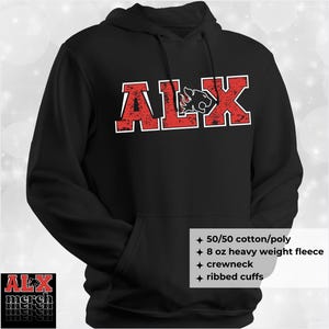 May include: Black hooded sweatshirt with the word "ALX" in red distressed lettering with a white outline. The "L" is replaced with a panther head graphic. Features include a crewneck, ribbed cuffs, and 50/50 cotton/poly blend.