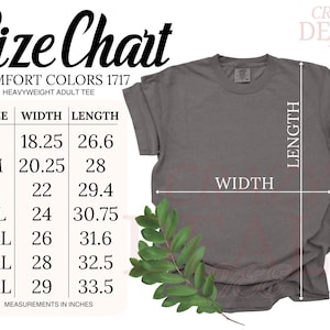 以下が含まれることがあります： グレーのComfort Colorsヘビーウェイト大人用Tシャツとサイズチャート。チャートは、Sから4XLまでのサイズのインチ単位の測定値を示しています。シャツの左下隅には緑の葉の小枝があります。