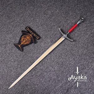 May include: A long sword with a silver crossguard and a red handle, next to a black and gold Elden Ring emblem. The sword has a light-colored blade and a decorative pommel. The Ayaka BladeStudio logo is in the bottom right corner.