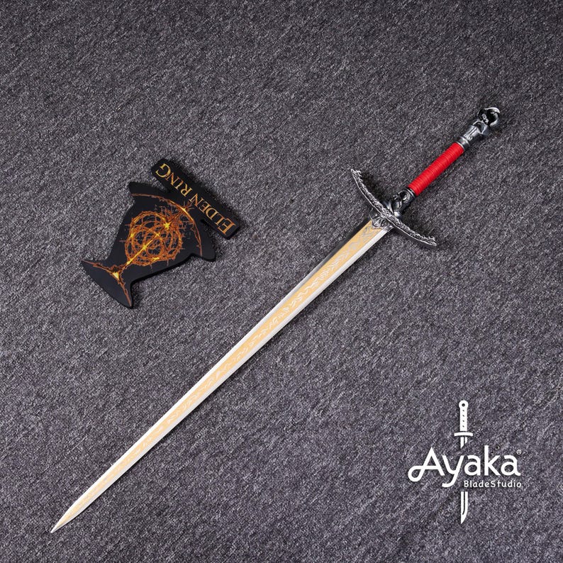 May include: A long sword with a silver crossguard and a red handle, next to a black and gold Elden Ring emblem. The sword has a light-colored blade and a decorative pommel. The Ayaka BladeStudio logo is in the bottom right corner.