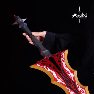 May include: A black and red fantasy sword with a star-shaped pommel and a blade featuring a red and white design. The sword is held against a black background, showcasing the intricate details and craftsmanship.