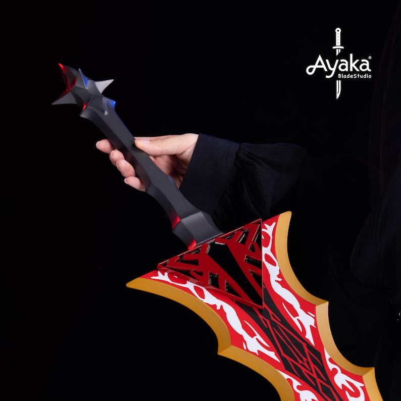May include: A black and red fantasy sword with a star-shaped pommel and a blade featuring a red and white design. The sword is held against a black background, showcasing the intricate details and craftsmanship.