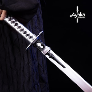 May include: A detailed view of a katana sword with a silver and black handle and a polished blade. The handle features a diamond pattern. The sword is held against a black background. The logo "Ayaka BladeStudio" is visible.