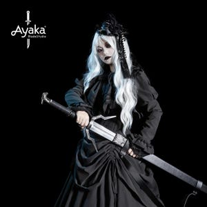 May include: A person in a black gothic outfit with white hair holds a large sword. The sword has a silver blade and a black handle. The image includes the text "Ayaka BladeStudio" in the upper left corner.