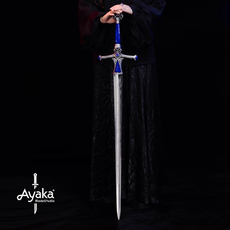 May include: A long, silver sword with a blue and silver hilt. The sword has a detailed design on the hilt and crossguard. The blade is straight and has a textured appearance. The sword is held against a black background.