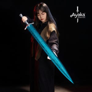 May include: A long, blue sword with a detailed pattern on the blade. The sword has a silver handle and crossguard. The image is set against a dark background. The sword is held by a person.