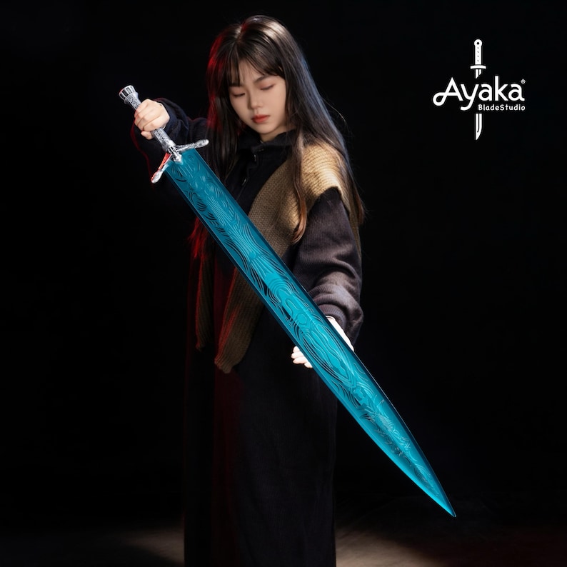 May include: A long, blue sword with a detailed pattern on the blade. The sword has a silver handle and crossguard. The image is set against a dark background. The sword is held by a person.