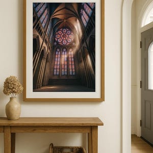 May include: A framed print of a cathedral interior. The image showcases a high-ceilinged space with stained-glass windows in shades of red, blue, and purple. The artwork is displayed on a wall above a wooden table with a vase and a woven basket.
