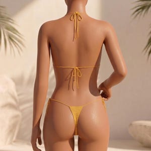 May include: A bright yellow crochet bikini set featuring a triangle top with thin halter neck ties and a matching thong-style bottom with adjustable side ties. The garment is constructed from a fine, textured knit fabric with visible stitching.