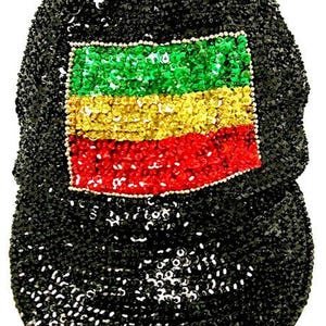 May include: A black baseball cap covered in small, reflective sequins. The front panel features a rectangular patch made of green, yellow, and red sequins arranged in horizontal stripes, outlined with a thin border of small silver beads.
