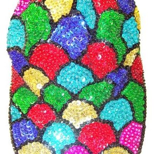 May include: A baseball cap covered in a vibrant, multi-colored sequin pattern. The design features individual patches of red, blue, green, yellow, turquoise, and hot pink sequins, each separated by thin black outlines, creating a mosaic effect.