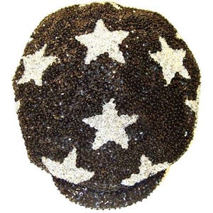 May include: A black and silver sequined hat with a star pattern. The hat is covered in small, shiny black sequins, with large, white star shapes evenly spaced across the surface. The hat has a rounded crown and a small, curved brim.