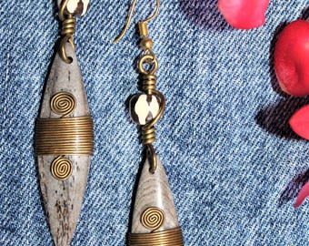 Handmade African artisan drop earrings with elongated carved bone pendant accented with coiled brass wire