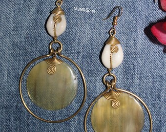 Handmade African dangle earrings with cowrie shells and circular cow horn discs accented with polished brass wire