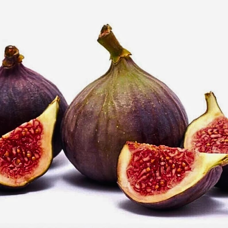 May include: Several ripe figs, some whole and some sliced, are arranged on a white surface. The figs have a deep purple exterior with a green stem and a vibrant red interior filled with tiny seeds. The sliced figs reveal the juicy, textured flesh.