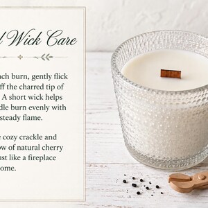 May include: A white candle in a textured clear glass jar with a wooden wick, accompanied by a wooden wick trimmer. The text reads: Wood Wick Care. Before each burn, gently flick or trim off the charred tip of the wick. A short wick helps your candle burn evenly with a bright, steady flame. Enjoy the cozy crackle and warm glow of natural cherry wood&mdash;just like a fireplace in your home.