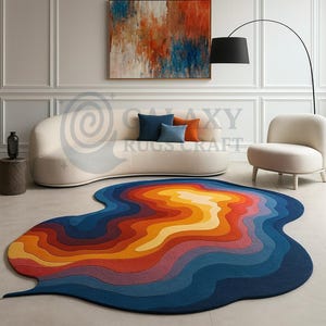 May include: A colorful, abstract area rug with a unique, organic shape. The rug features a gradient of colors, including shades of blue, orange, yellow, and red. The rug's design resembles a flowing liquid or a stylized landscape.