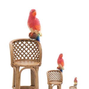 May include: Three wicker bar stools with red and yellow parrots perched on the top of each stool. The stools are made of woven wicker and have a natural brown colour.