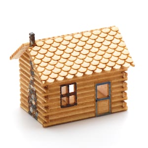 May include: A miniature wooden cabin with a shingled roof, a small window, and a door. The cabin is made of logs and has a chimney on the roof.
