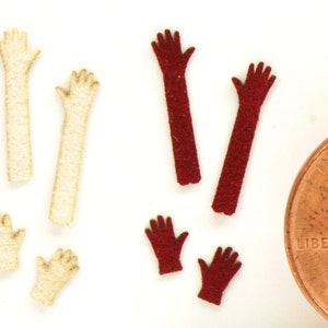 May include: Assortment of felt craft supplies in various colors, including blue, cream, and red. The felt pieces are shaped like arms and hands, perfect for crafting projects.