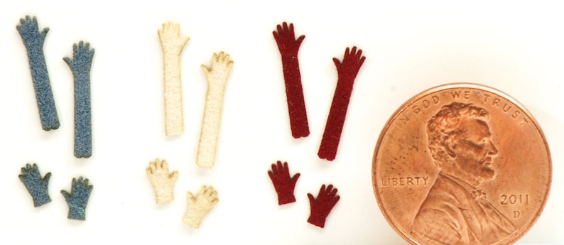 May include: Assortment of felt craft supplies in various colors, including blue, cream, and red. The felt pieces are shaped like arms and hands, perfect for crafting projects.