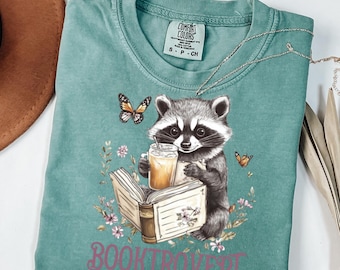 Comfort Colors Raccoon Reading Book T-Shirt, Cute Booktrovert Shirt,Cottagecore Book Reader Shirt,Animal Lover Book Shirt, Floral Book Worm