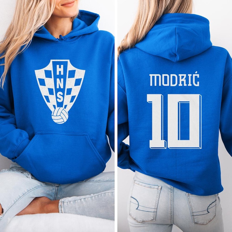 A woman wearing a blue hoodie with a white logo and the number 10 on the back.