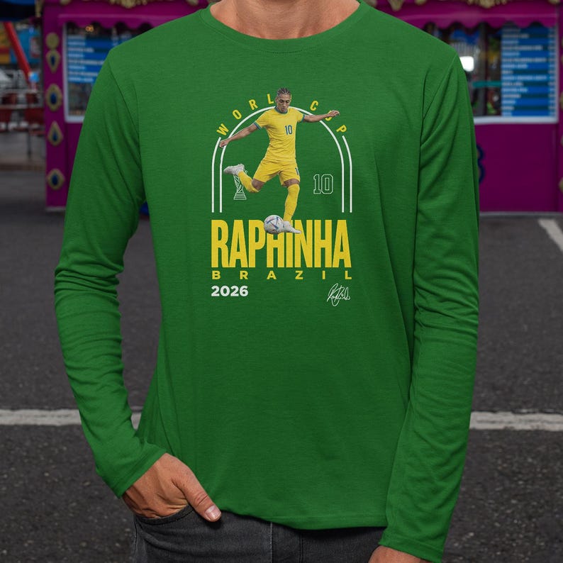 A man wearing a green long-sleeved shirt with a graphic design featuring a soccer player and text related to the World Cup.