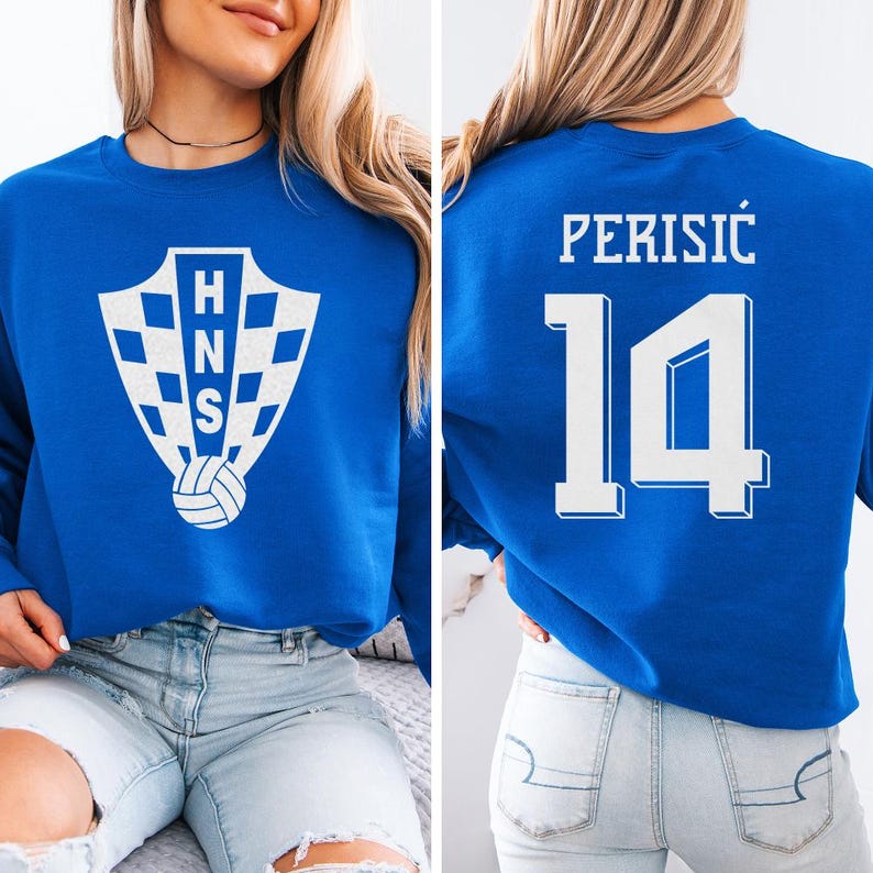 A woman wearing a blue sweatshirt with a white logo and the number 14 on the back.