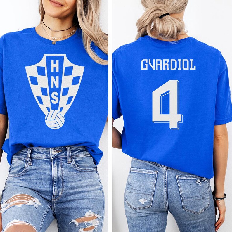 A woman wearing a blue t-shirt with a white shield logo and the name 'GVARDIOL' printed on it, along with the number '4'.