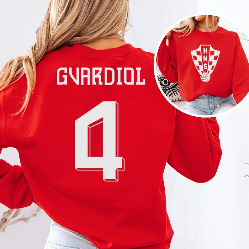 A woman wearing a red sports jersey with the number 4 and the name 'Guardiol' printed on it.