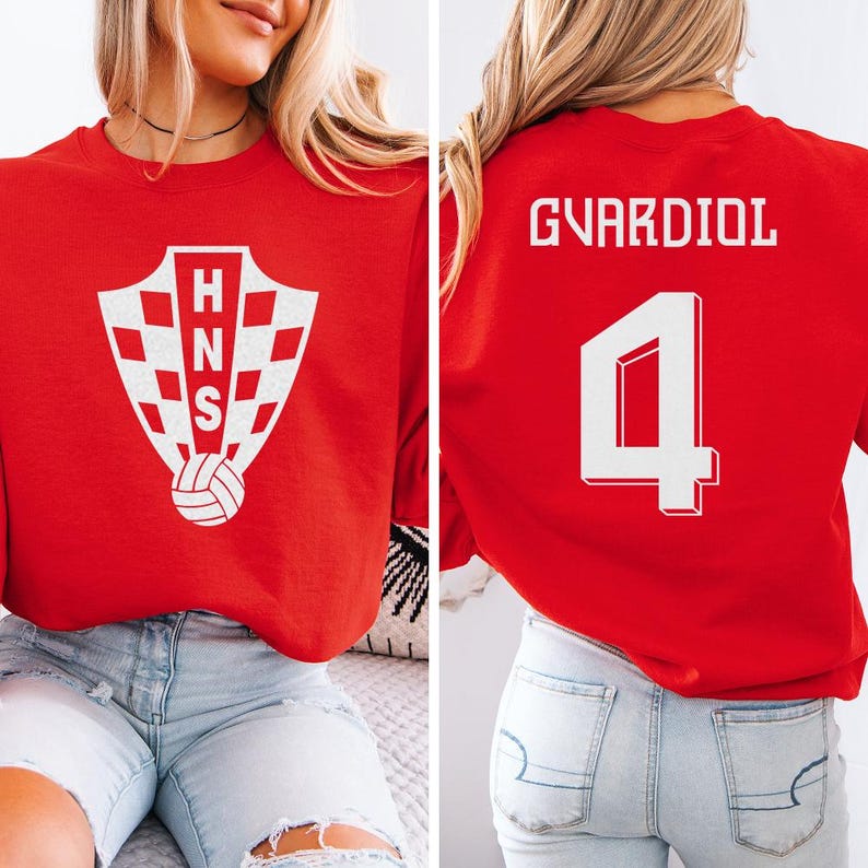 A woman wearing a red shirt with a white crest and the number 4 on the back, along with the name 'GVARDIOL' printed on the back.