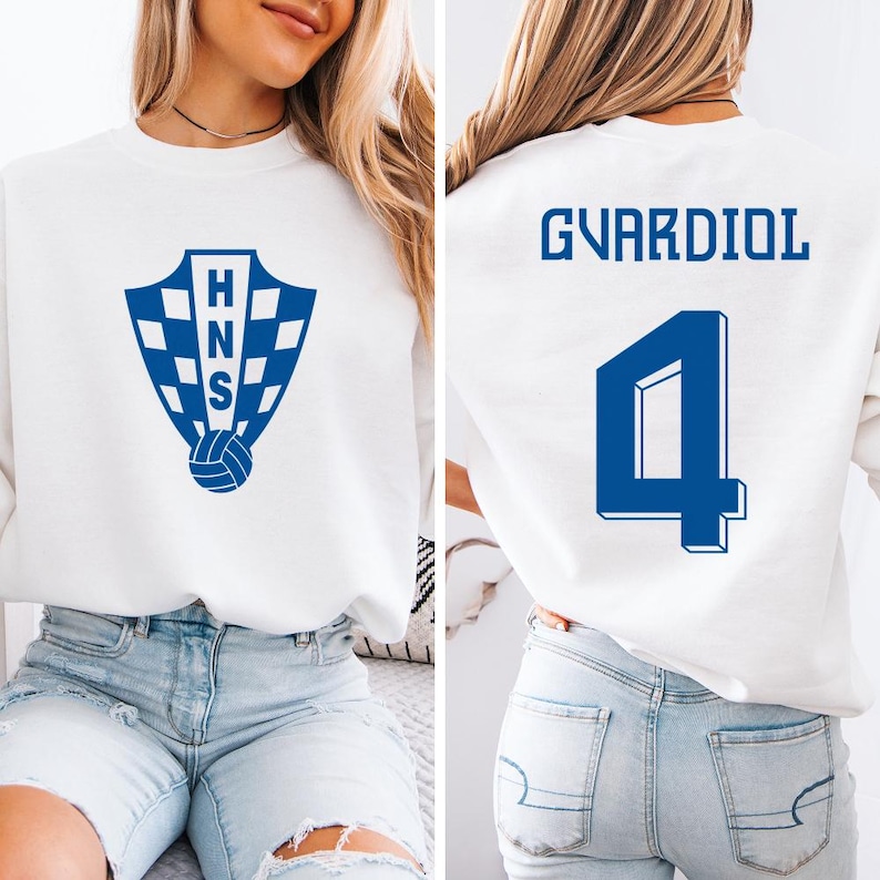A woman wearing a white sweatshirt with a blue logo and the number 4 on the back.