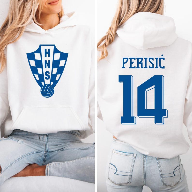 A woman wearing a white hoodie with a blue logo and the number 14 on the back.