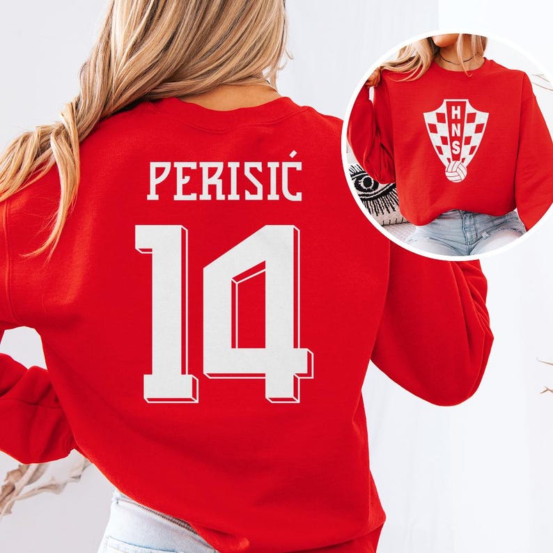 A woman wearing a red sweater with the number 14 and the word "PERISIC" printed on it.