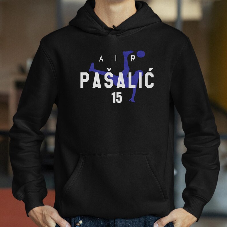 A person wearing a black hoodie with a graphic design on it.