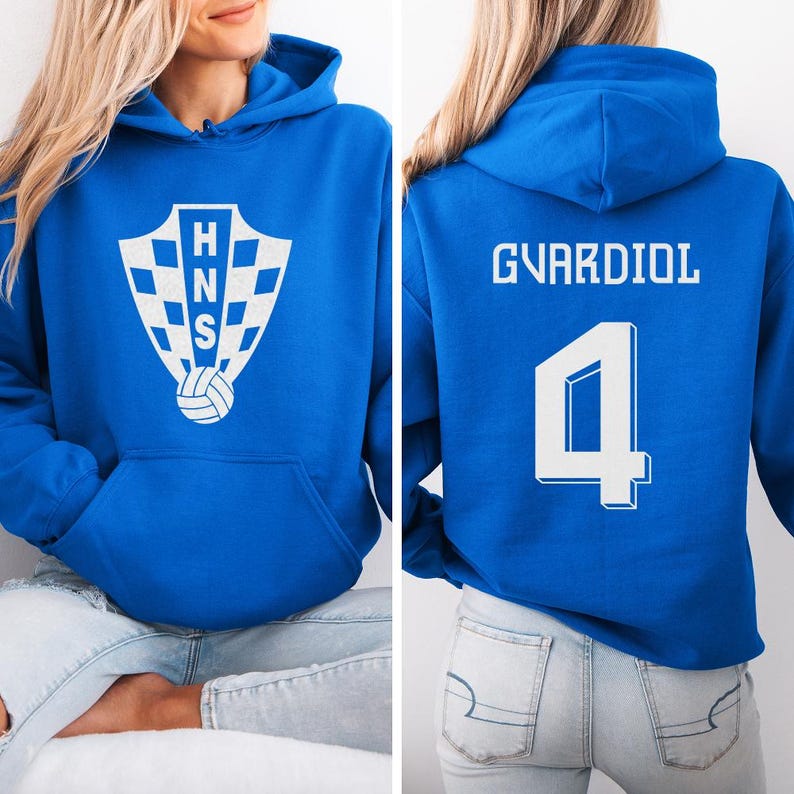 A woman wearing a blue hoodie with a white logo and the number 4 on the back.