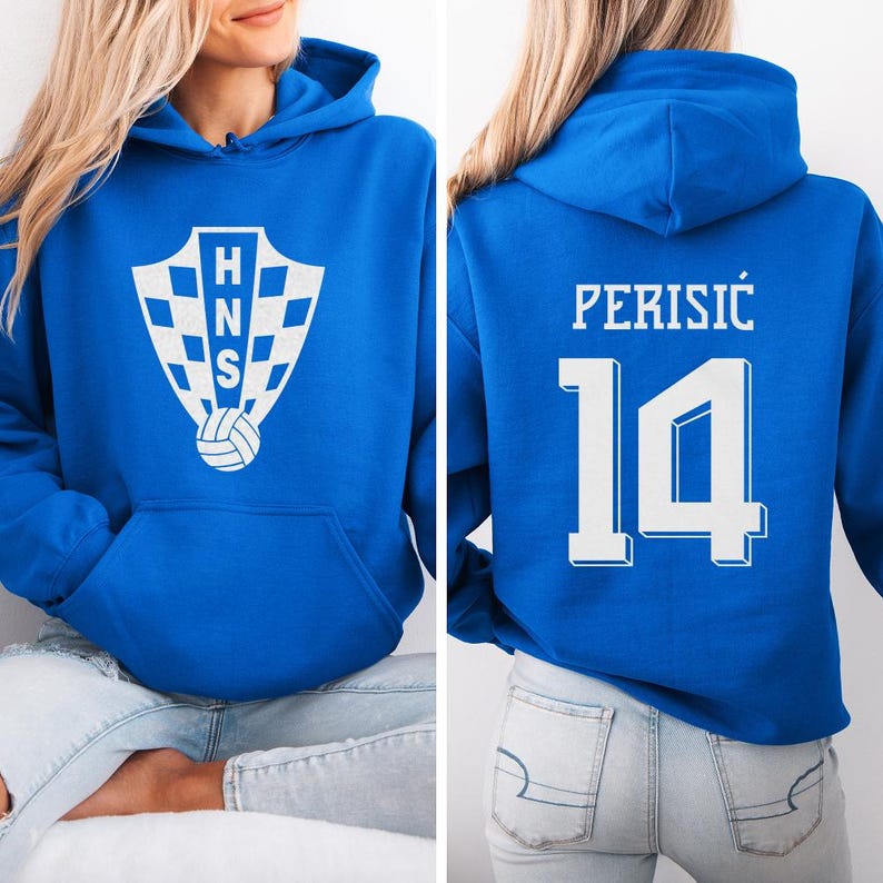A woman wearing a blue hoodie with a white logo and the number 14 on the back.