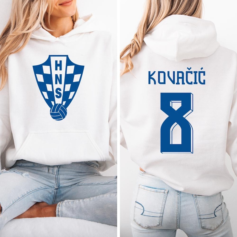 A woman wearing a white hoodie with a blue logo and the number 8 on the back.