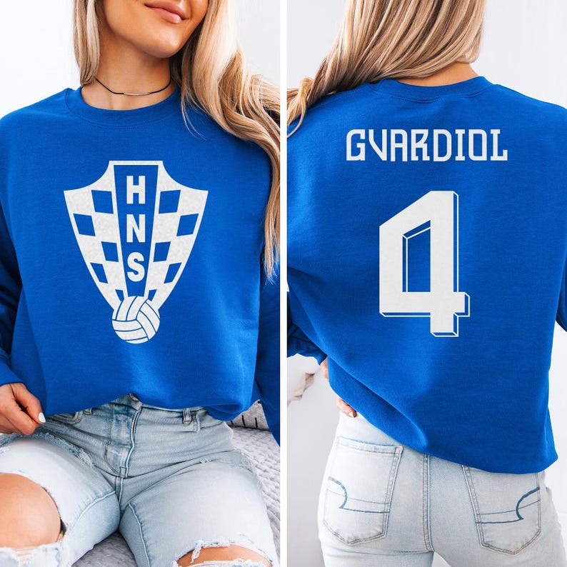 A woman wearing a blue sweatshirt with a white logo and the number 4 on the back.