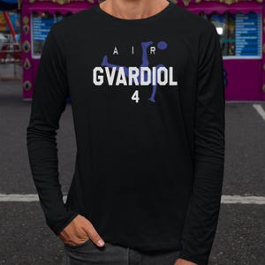 A person wearing a black long-sleeved shirt with a graphic design on it.