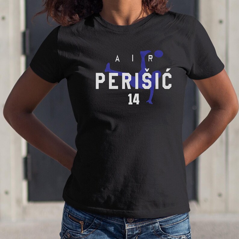 A woman wearing a black t-shirt with the text "AIR PERISIC 14" printed on it.